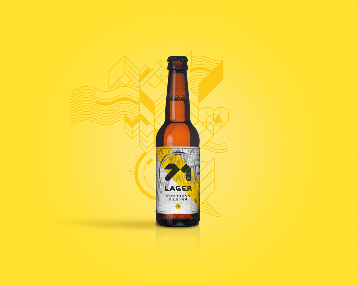 Bottle of lager with a diagonal yellow stripe on the label sits on a yellow background.