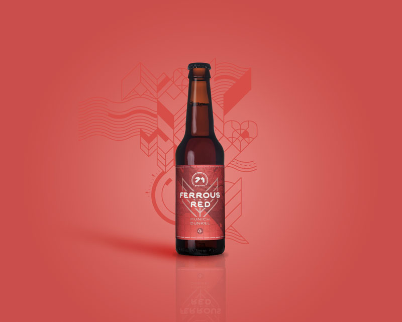 Ferrous Red lager bottle with red label sits on red background.