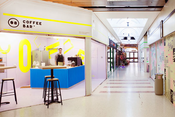 Bright and vibrant coffee bar within 1970s shopping centre.