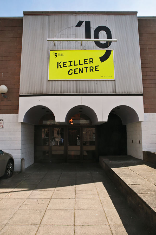 Entrance to the Keiller Centre with luminous yellow backing and black branding for the 2019 Dundee Design Festival.