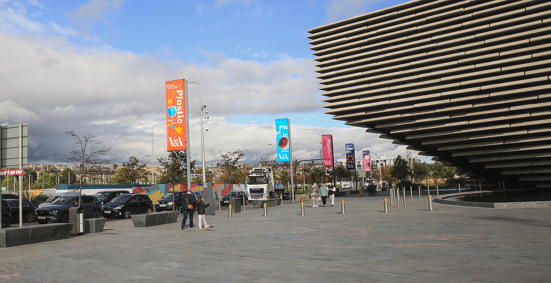 Photo from outside V&A Dundee showing the four different banner designs promoting the Plastic: Remaking our world exhibition.